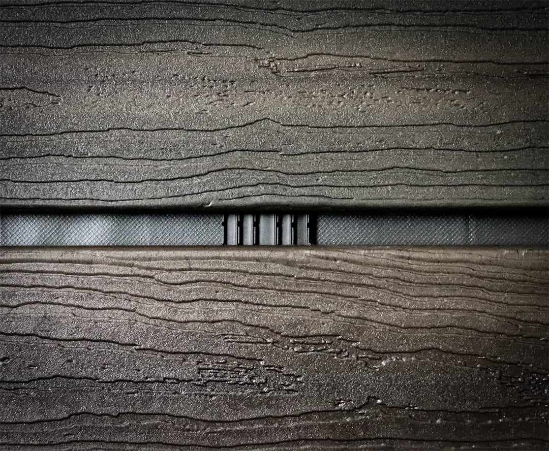 Close up of a Batten UV strip installed behind wood open joint cladding.