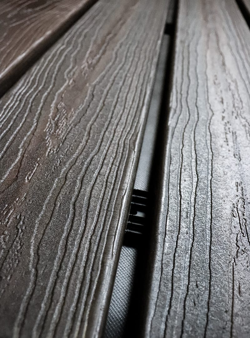 A Batten UV strip installed between the space of wood open joint cladding