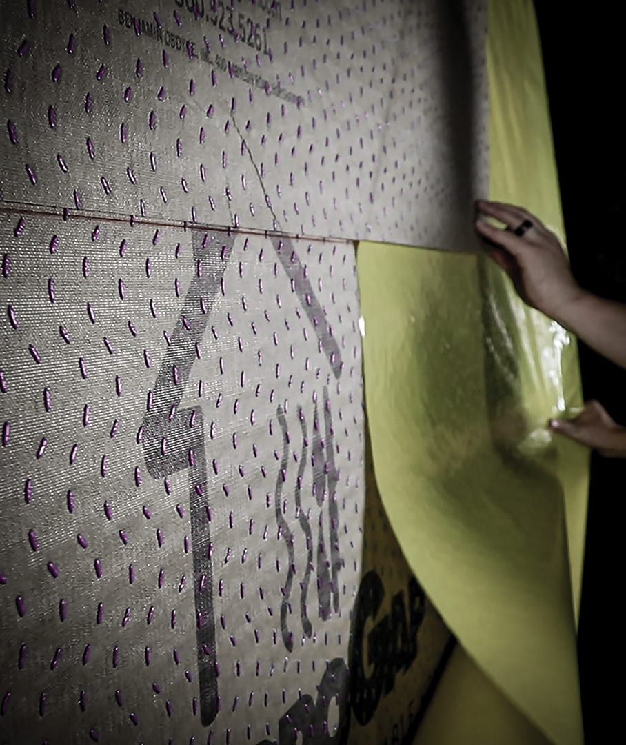 Peeling of the split-release liner during a HydroGap SA drainable housewrap installation.