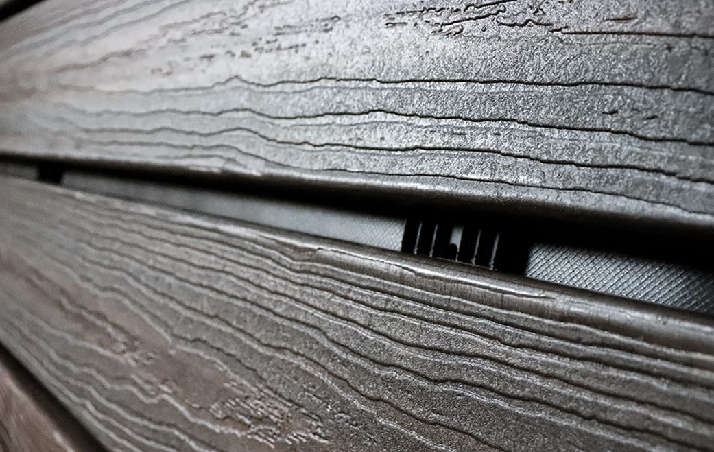 Composite siding open-joint cladding installation with InvisiWrap UV housewrap and Batten UV furring strips.